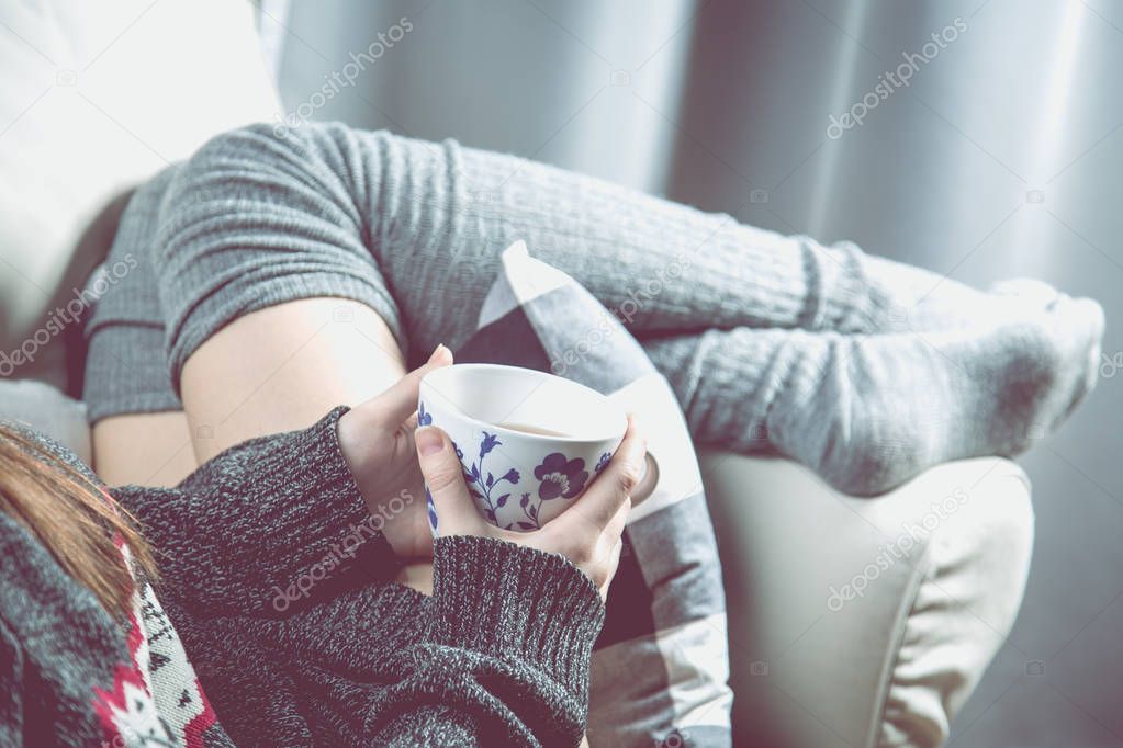 Relaxing concept with hot tea and sofa