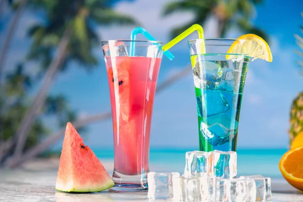 Set of exotic drinks on the beach with blue ocean background