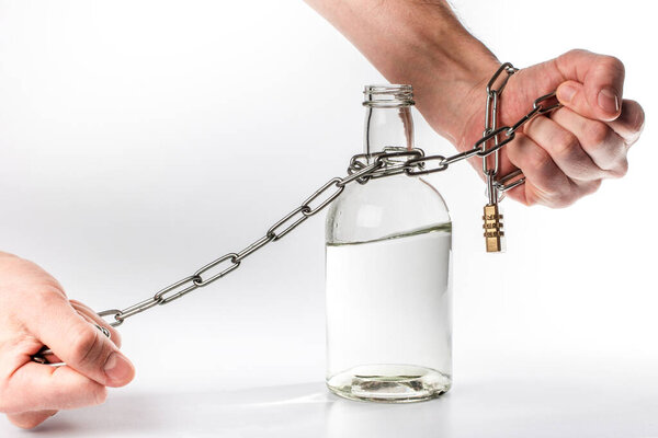 bottle of alcohol tied to the hands of a metal chain