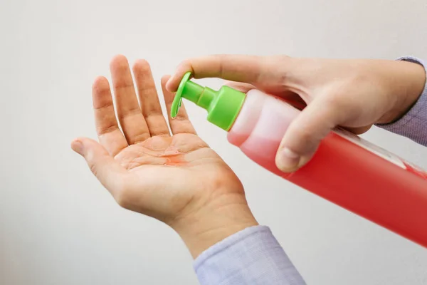 Man holds sanitizer gel for cleaning hand and used as disinfectant against coronavirus with alcohol gel. Prevention of covid-19 and other virus and bacteria.