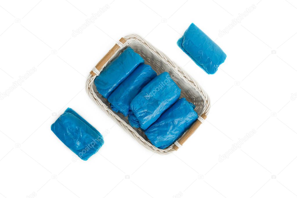blue disposable shoe covers on white background.