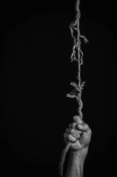 O homem agarra-se a uma corda que se separa . — Fotografia de Stock