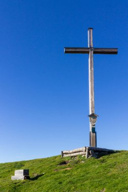 Top with Summit Cross of Mount Rauheck, 1590 m in Bavarian Prealps, located near Ohlstadt, Upper Bavaria, Germany. Europe