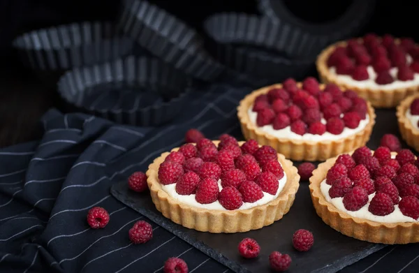 Delicious raspberry mini tarts on dark background — Stock Photo, Image