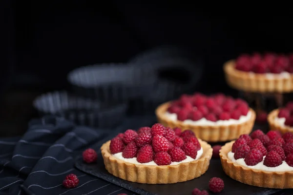 Delicious raspberry mini tarts on dark background — Stock Photo, Image