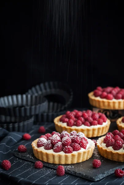 Delicious raspberry mini tarts on dark background — Stock Photo, Image