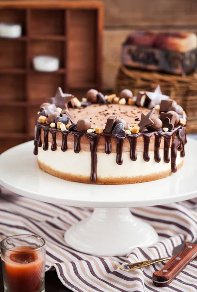 Två skikt chokladcheesecake dekorerad med godis och glasyr — Stockfoto