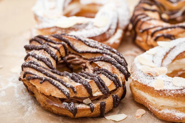 Chocolate and powdered sugar cream puff rings (choux pastry) — Stock Photo, Image