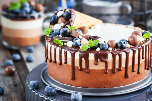 Three chocolate mousse cake decorated with waffle cone