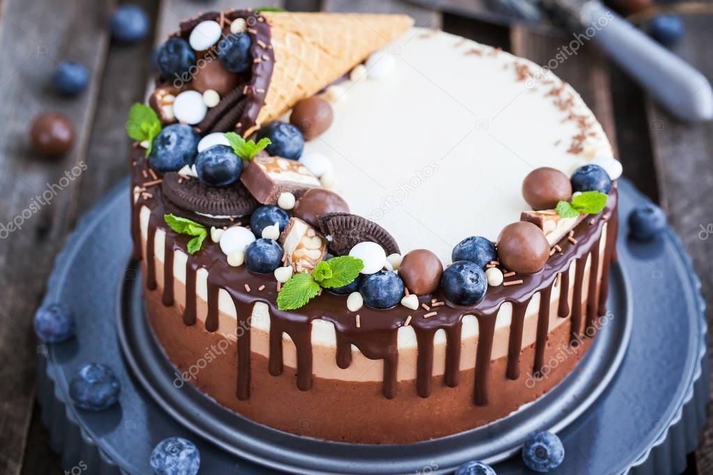 Three chocolate mousse cake decorated with waffle cone