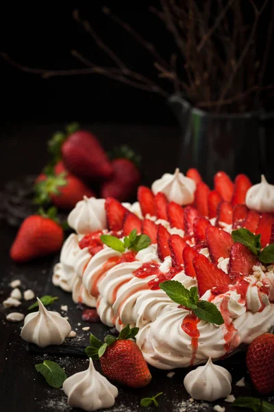 Pavlova meringue cake decorated with fresh strawberry