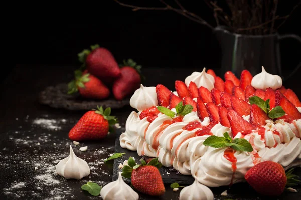 Pavlova meringue cake decorated with fresh strawberry