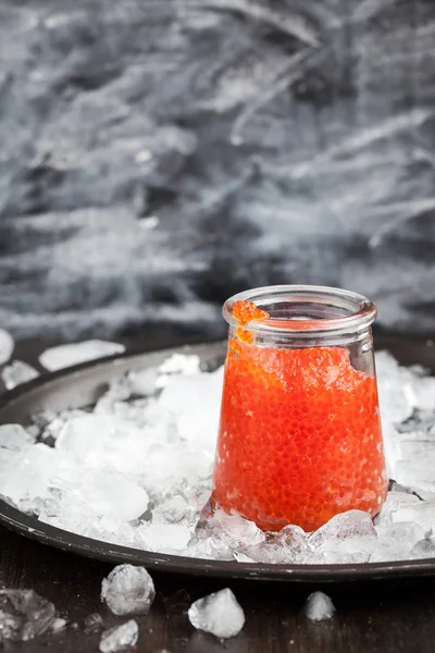 Red caviar in a glass jar — Stock Photo, Image
