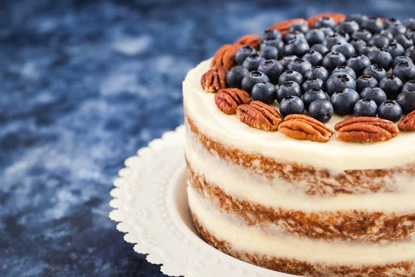 Naked carrot cake decorated with fresh blueberry and pecan — Stock Photo, Image