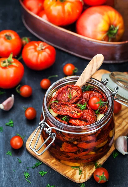 Sun dried tomatoes with garlic and olive oil in a jar — Stock Photo, Image