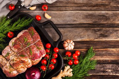 Raw pork meat with spices, ready to cook, on  dark background, t