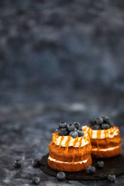 Delicious carrot individual cakes with caramel sauce, cream chee