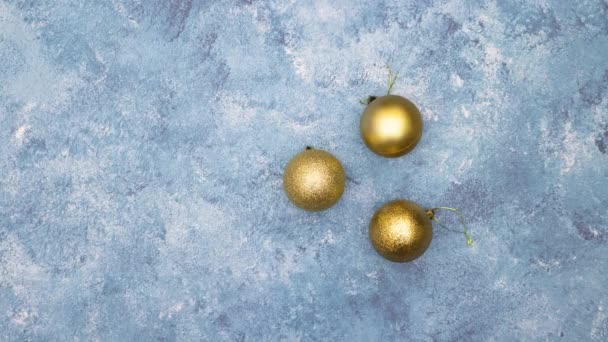 Stop Motion Animation Gold Christmas Balls Appear Blue Background — Stock Video
