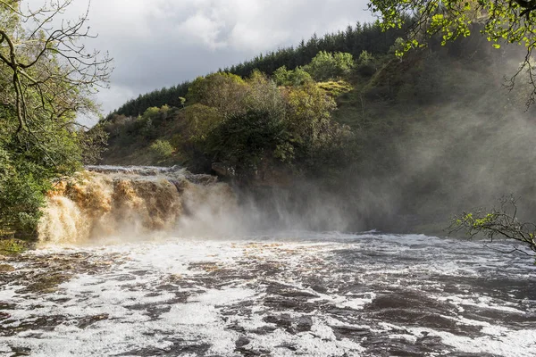 İngiltere 'nin Northumberland ve Cumbria eyaletlerinin sınırındaki Irthing Vadisi' ndeki Crammel Linn şelalesinde akan hızlı akarsu..