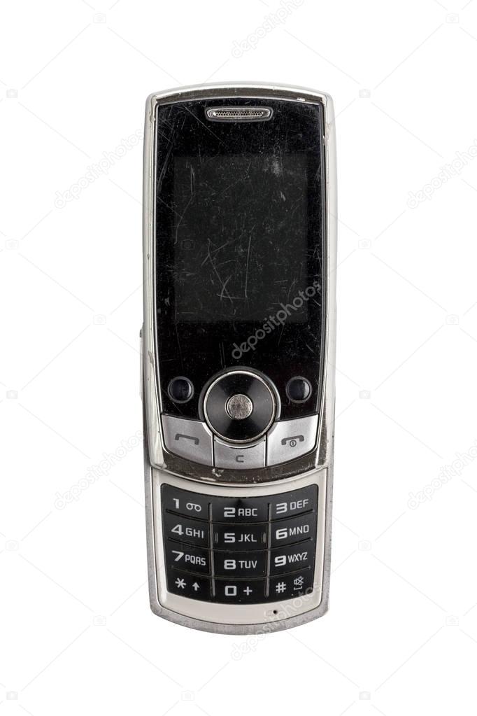 very old scratched mobile phone, isolated on white