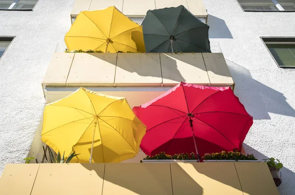 Balconies in the summer with colorful parasols — Stock Photo, Image