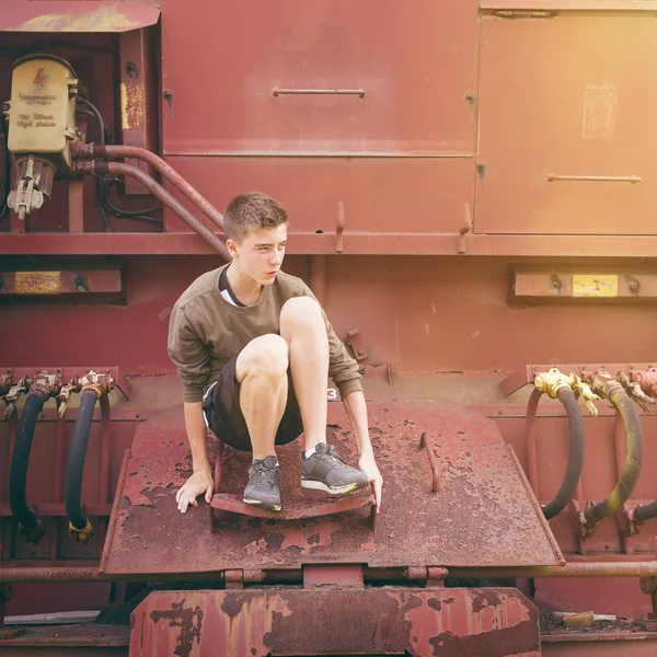 Portrait of a young man climbing on industry equipment — Stock Photo, Image
