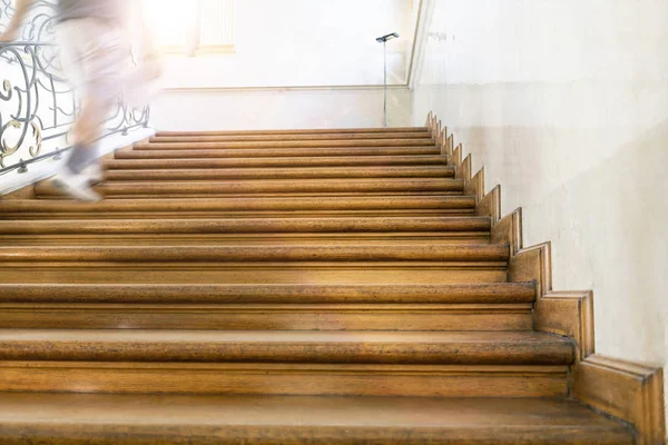 Motion blur, man goes upstairs, old wooden stairs — Stock Photo, Image