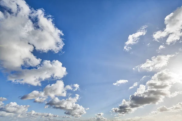 Cloudscape with blue sky and sun for backgrounds — Stock Photo, Image