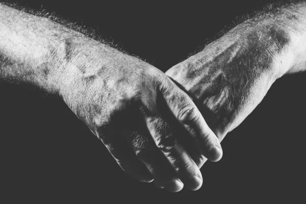 One hand covers the other hand, in black and white — Stock Photo, Image