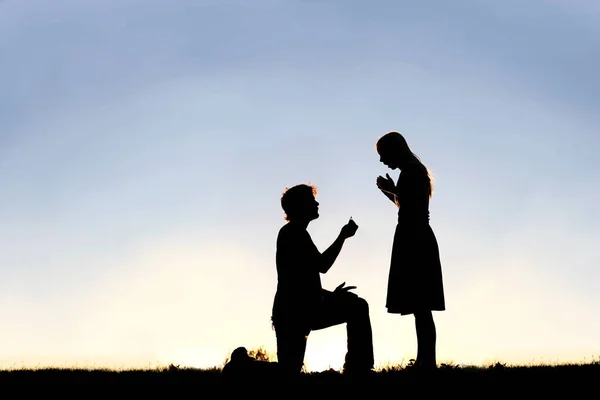 Silhouette of Young Man with Engagement Ring Proposing to Woman — Stock Photo, Image