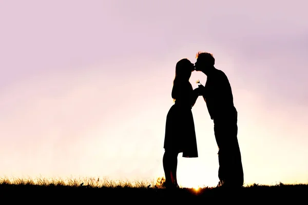 Silhouette of Loving Young Couple Kissing Outside on Date at Sun — Stock Photo, Image
