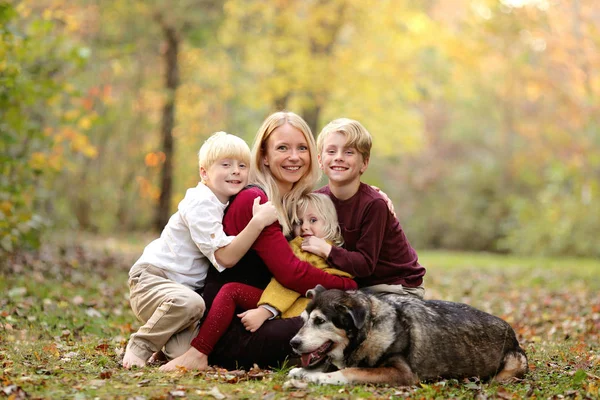 Gelukkig moeder en haar drie lachende jonge kinderen en huisdier hond Ou — Stockfoto