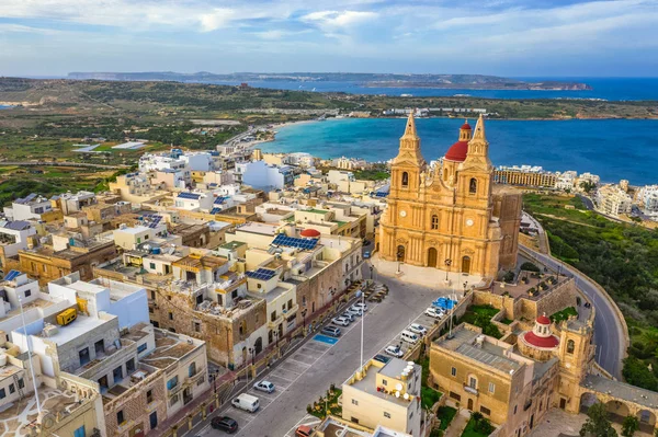 Aerial view of The Parish Church in Melieha city and road. Blue sky, sea, day. Winter landscape. Malta island