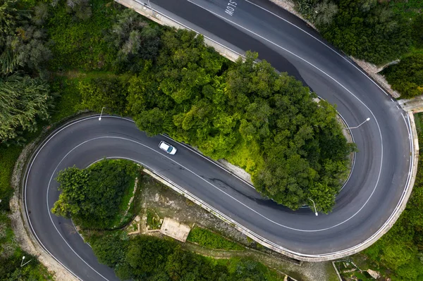 Car on the curves road in Mellieha city. Aerial view. Malta country