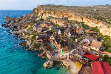 Popeye village. Sunny day, blue sea. Mellieha city. Malta island clipart