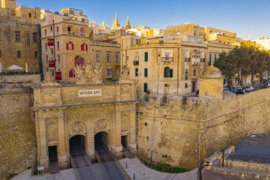 Victoria gate in Valletta, the capital city of Malta country. The traditional houses, buildings and maltese balcony. Sunset, blue sky