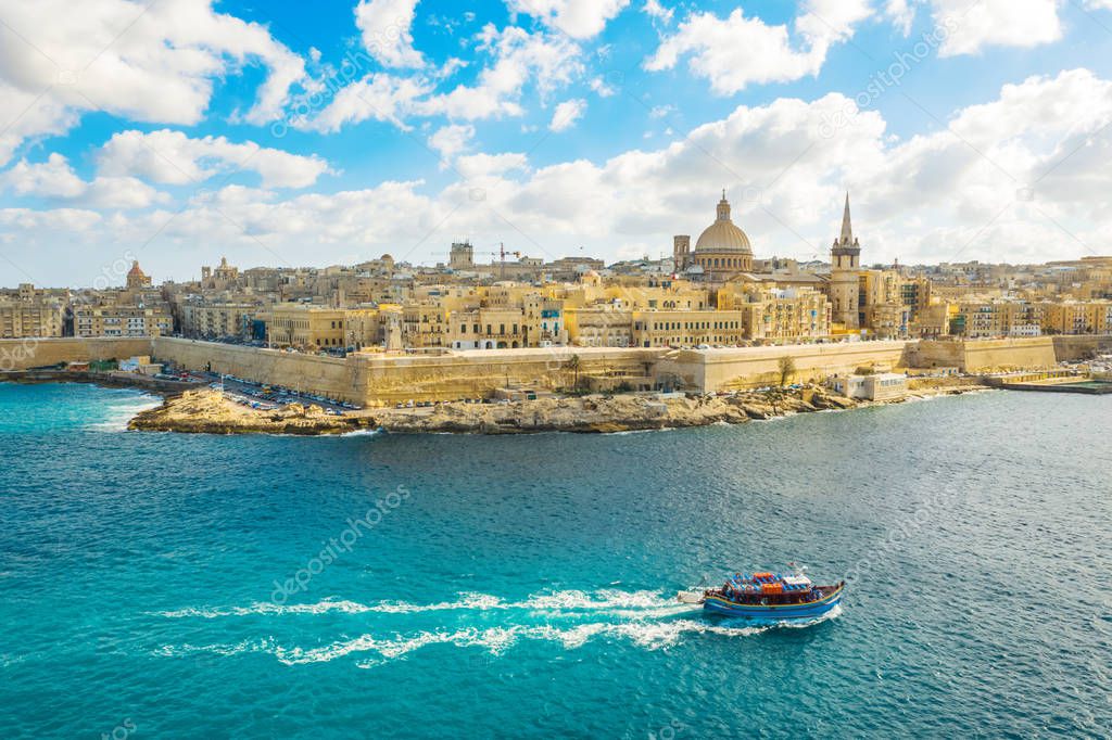 Aerial view of  Valletta city - capital of Malta country. Tourist boat in Mediterranean sea