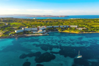 Aerial panorama view of nature landscape in Mellieha city. Mediterranean blue sea, boat, hotel and forest. Malta island clipart