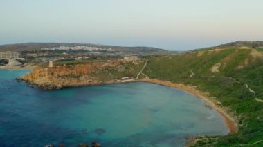 Doğa manzarasının havadan görünüşü. Ünlü kum Malta Ghajn Tuffieha plajı, Akdeniz. Kamera ileri gidiyor. Malta ülkesi