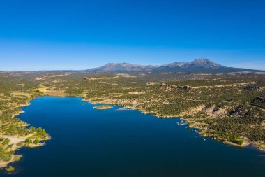 Manzaranın havadan görünüşü. Mavi gökyüzü ve göl, dağların suda yansıması. ABD 'nin Utah eyaletindeki rezervuarı ele geçirin.