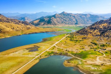 Sequoia Ulusal Parkı 'nın dışındaki Kaweah Gölü Rekreasyon Alanı' nın havadan görünüşü. Kuru yeşil çimenler, mavi gökyüzü, sarı dağlar, sabah, mavi su. Sonbahar. Kaliforniya, ABD 