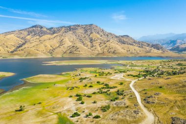 Amerikan Doğa Manzarası 'nın havadan görünüşü. Göl, yeşil çimen, mavi gökyüzü, sarı dağlar, sabah, mavi su. Sonbahar manzarası. Kaliforniya, ABD