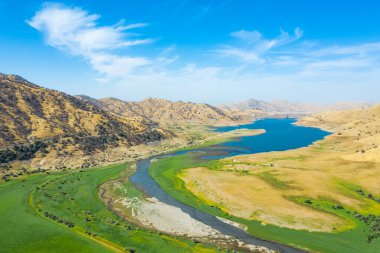 Eğlence Alanının havadan görünüşü. Yeşil çimenler, mavi gökyüzü, dağlar, sabah, mavi su. Sonbahar manzarası. Kaliforniya, ABD