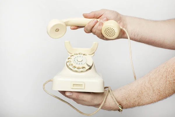 Male hand holds an obsolete telephone receiver 로열티 프리 스톡 사진