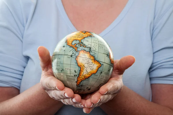 Two female hands hold earth globe. With the white background.