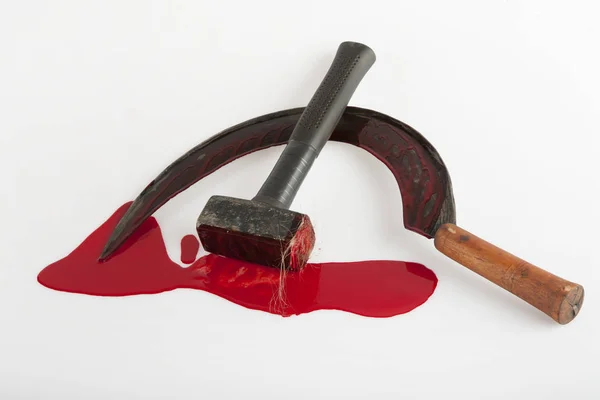 Hammer and sickle smeared with blood — Stock Photo, Image
