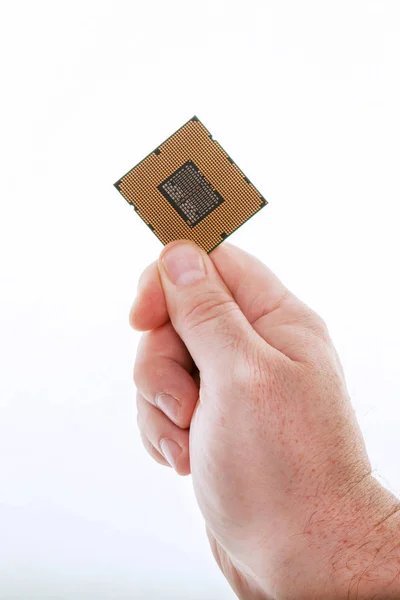 Una mano con la CPU Immagine Stock