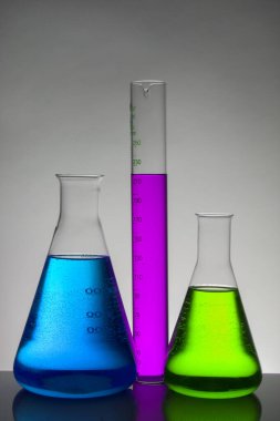 Laboratuvar şişelerinde sıvı. Bilimsel biyokimya laboratuvarı. Renkli sıvı.