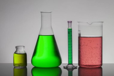 Laboratuvar şişelerinde sıvı. Bilimsel biyokimya laboratuvarı. Renkli sıvı.
