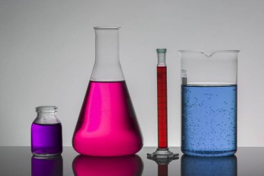 Laboratuvar şişelerinde sıvı. Bilimsel biyokimya laboratuvarı. Renkli sıvı.